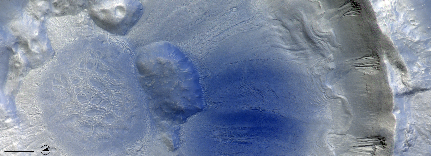 The south wall of this crater close to the dichotomy boundary has three large gully structures that have contributed to the build-up of material at the base of the crater wall. There seem to be flow features leading down to the centre of the crater where there is a remarkable structure with fractures.