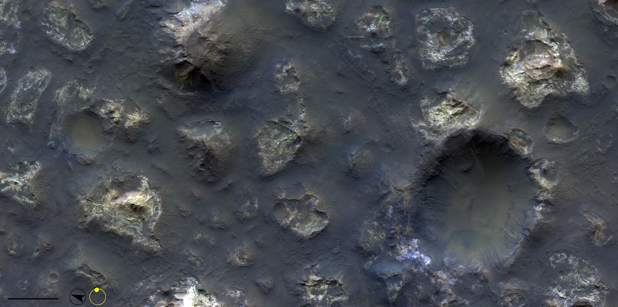 This image is of a small unnamed area in Terra Cimmeria that is known for containing chaotic terrain. However, the structures here are very different from those found in, for example, Aram Chaos. The surface appears to have been heavily eroded, revealing bright, colourful material. The crater to the right shows exposed brighter bedrock in the rim and the west wall.